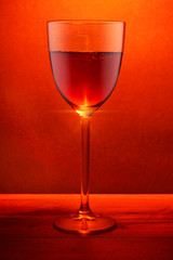 Glass of fortified red wine, red color and glow.
