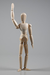 Wooden Mannequin on gray background