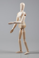 Wooden Mannequin on gray background