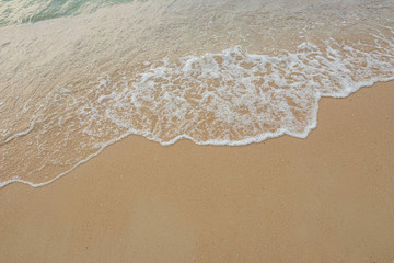 
Soft waves of the ocean on the sandy beach, summer beach, soft wave bubbles on the sandy beach