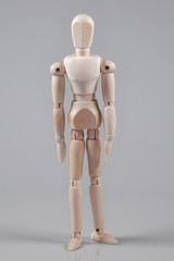 Wooden Mannequin on gray background