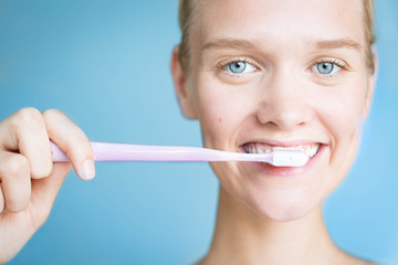 Beautiful woman brushing her teeth. Dental hygiene.