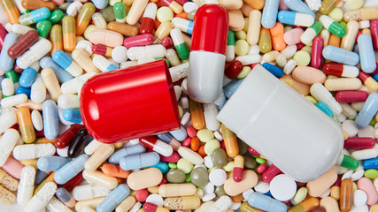 Large capsule is open on many medications