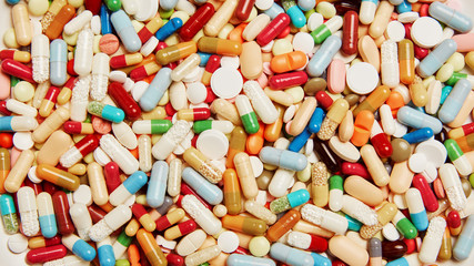 medicines drugs background with colorful capsule and pills