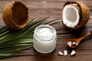 Fototapeta na wymiar Homemade coconut cream - still life with spoon - on dark wooden background