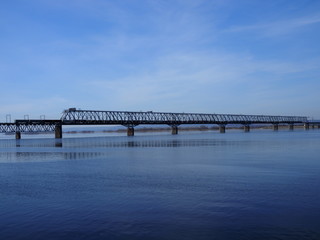 Railway bridge over the river. Sunny spring day.