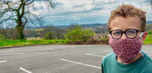 child wearing anti virus mask, outdoors