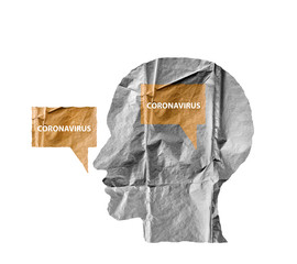Crumpled paper shaped as a human head and talk balloon on white. Paper human head with Coronavirus text. COVID-19 crisis concept.