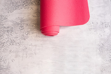 Yoga mat on white concrete background