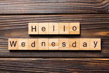 Hello wednesday word written on wood block. hello wednesday text on wooden table for your desing, concept © sosiukin
