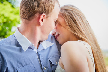 Young man and woman couple walk in the park. Spring or summer love story. Young happy family