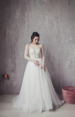 Portrait of a beautiful bride in wedding dress. Brunette woman  with hairstyle and fashion makeup.