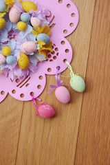 Easter background with colorful decorations on wooden background
