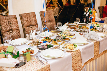 Beige table with food at the wedding.