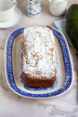 Homemade healthy zucchini and walnut bread, on blue rustic plate. 