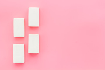 Soap bars flat lay on pink background top-down copy space frame