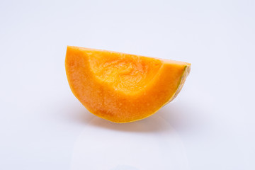 Fototapeta na wymiar Orange melon slice isolated in front of a white background