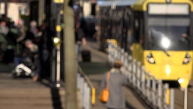 People in Manchester city commuting on trams UK 4K