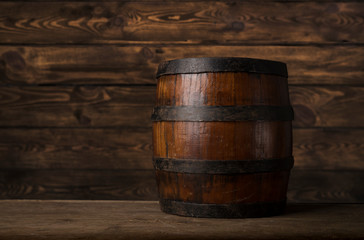 Old wooden barrel on a brown background