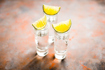 Tequila shots on the dark rustic background. Selective focus. Shallow depth of field.