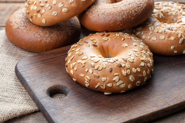 heap of fresh baked bagels on wooden background