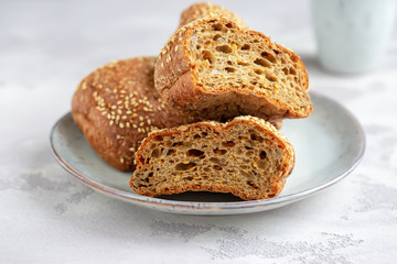 Protein bread (without flour) with linseeds, sunflower seeds and sesame seeds in wooden bowl. Selective focus. Natural light.
