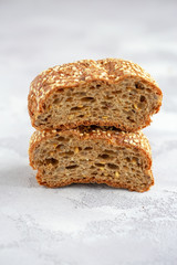 Protein bread (without flour) with linseeds, sunflower seeds and sesame seeds in wooden bowl. Selective focus. Natural light.