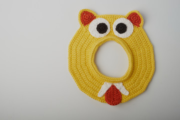 Fototapeta premium crochet Easter egg cup in chicken shape with easter eggs and greeen wool grass. white isolated background