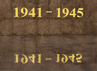 1941 and 1945 cracked numbers. Years of World War II by yellow gilded figures on a granite wall with reflection. May 9 Russian holiday Victory Day background template. Happy Victory day