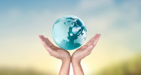 Globe , earth in human hand, holding our planet glowing.  image provided by Nasa