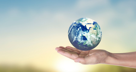 Globe , earth in human hand, holding our planet glowing.  image provided by Nasa