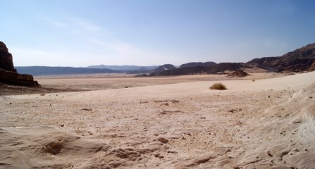 Fototapeta na wymiar Beautiful panorama of the Sinai Desert. Mountains and sands of different shades. Clear blue sky