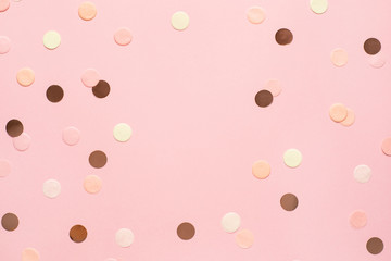 Pink,gold and yellow confetti on pink color paper background minimal style