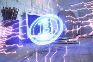 Multi exposure of blockchain and crypto economy theme hologram and table with computer background....