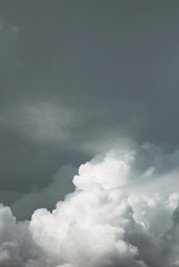 white blurred cumulus clouds on dark blue sky