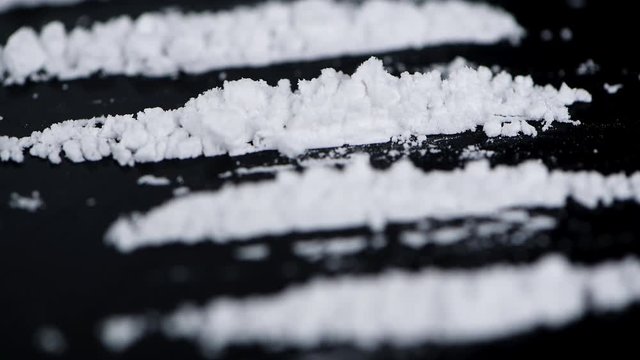 Portion of rotating Cocaine on a dark plate (seamless loopable)