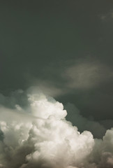 white blurred cumulus clouds on dark blue sky