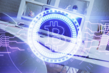 Multi exposure of blockchain and crypto economy theme hologram and table with computer background. Concept of bitcoin cryptocurrency.