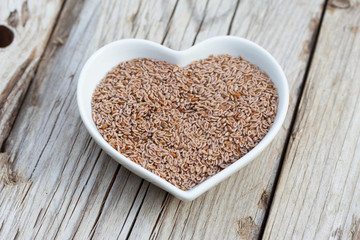 Portion of Psyllium Seeds on rustic wooden background. Natural light. Selective focus.