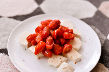 Mozzarella and tomatoes on white plate