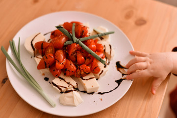 Mozzarella and tomatoes on white plate