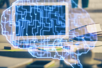 Double exposure of work space with computer and human brain drawing hologram. Brainstorm concept.