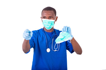 Fototapeta na wymiar young male doctor pointing holding medical mask and pointing fin