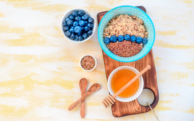 buckwheat porridge with fruits and honey, chia seeds, flax seeds, the concept of a healthy breakfast, diet, veganism, vitamins