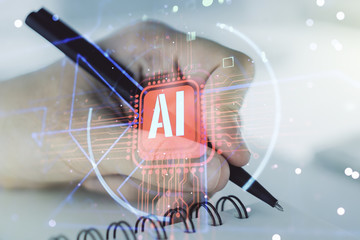 Double exposure of creative artificial Intelligence abbreviation with man hand writing in notepad...