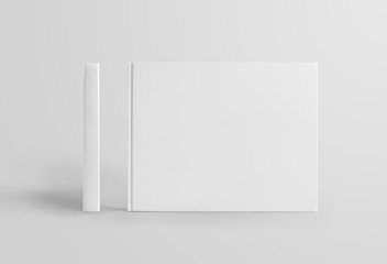 Set of standing white hardcover books landscape orientation, front and side view, isolated on background.