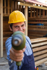 Handsome craftsman holding electric drill