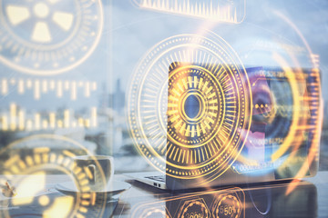 Computer on desktop in office with technology theme hologram. Multi exposure. Tech concept.