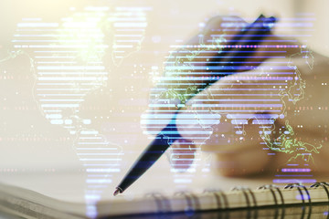 Double exposure of abstract digital world map and woman hand writing in notepad on background, big data and blockchain concept