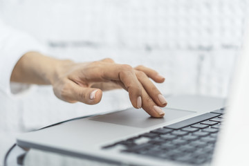 Woman working with laptop, business and technology concept. Close up